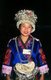 China: Young Miao woman with her distinctive silver headdress at a festival near Guiyang, Guizhou Province